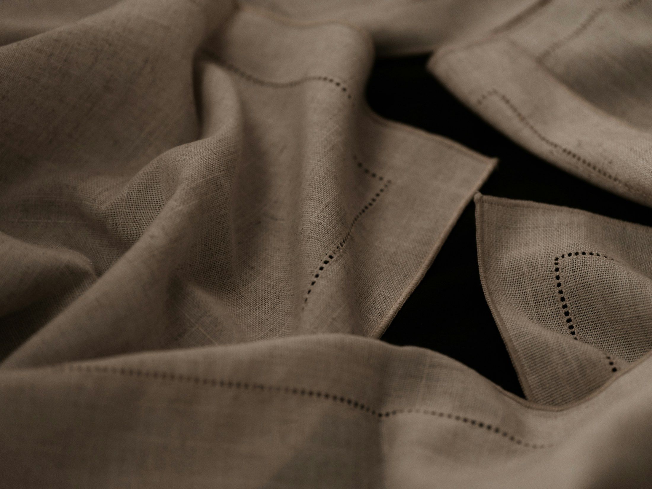 Soft folds of a handmade natural-material piece with a finished edge