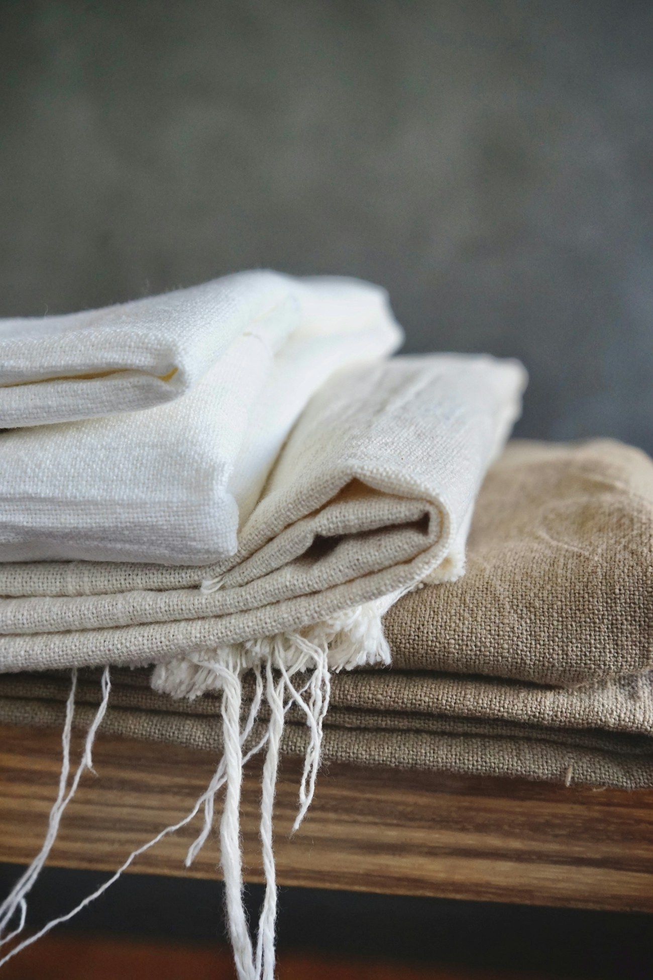 A stack of handmade natural napkins with frayed edges