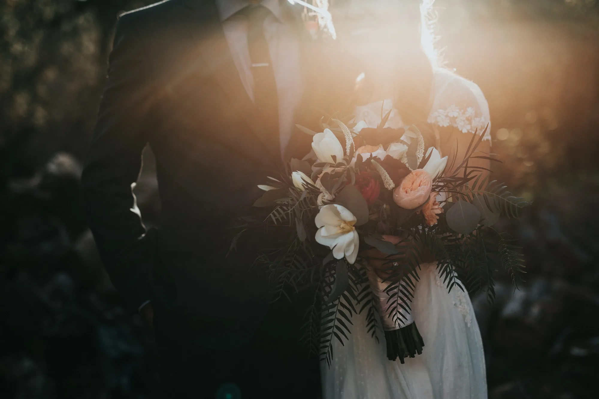 A couple on their wedding day, lit by soft late-afternoon light